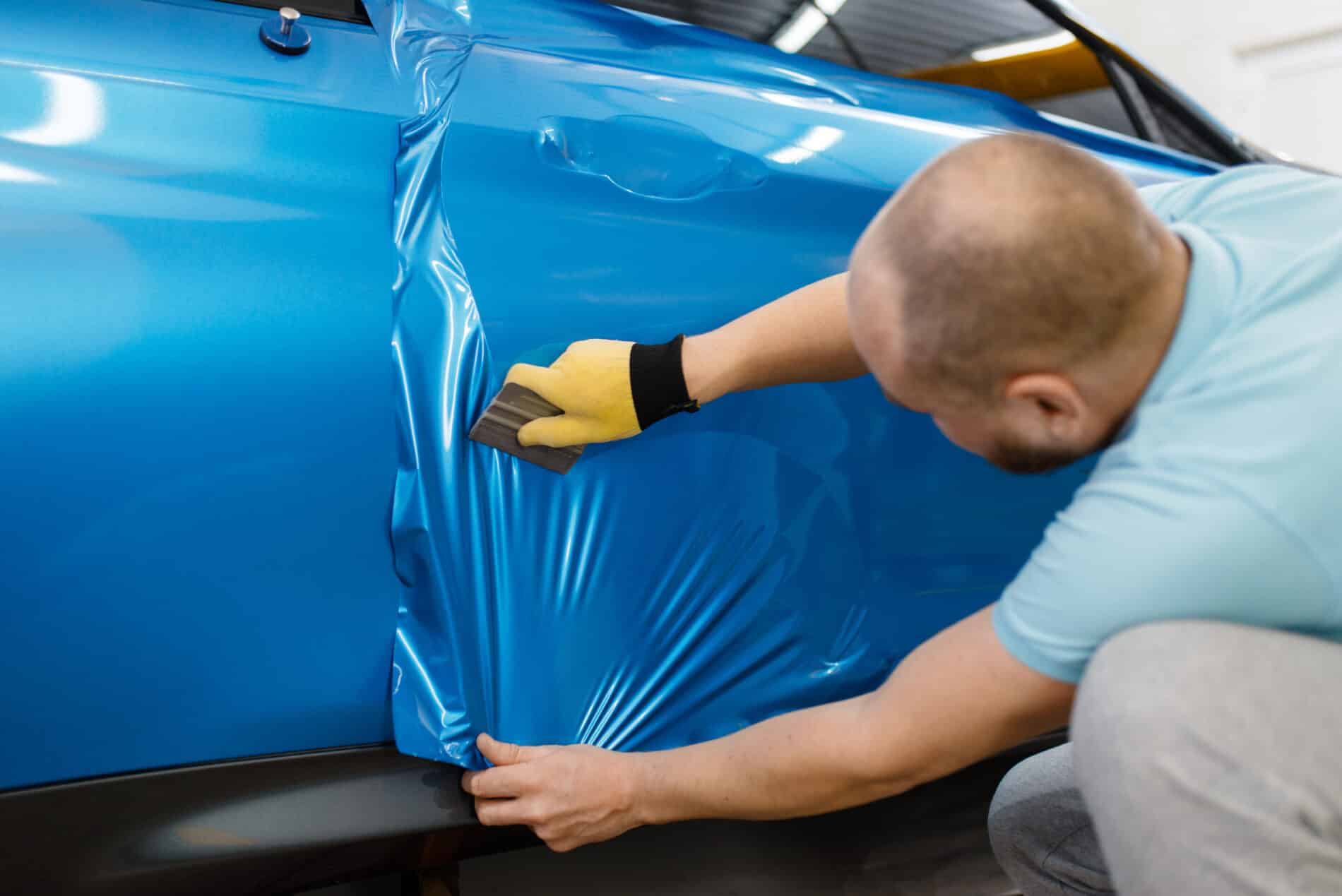 male mechanic installs protective foil or film 2024 12 02 04 29 11 utc scaled