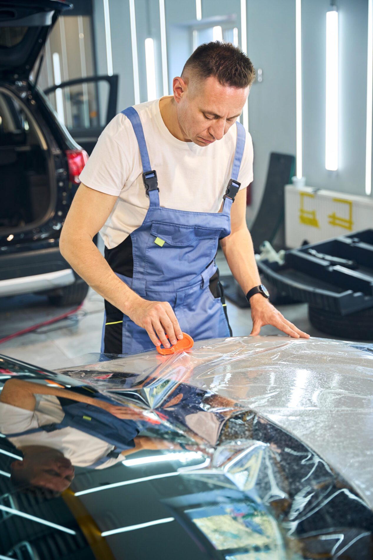 master glues the protective film on the car 2024 10 18 20 36 54 utc scaled