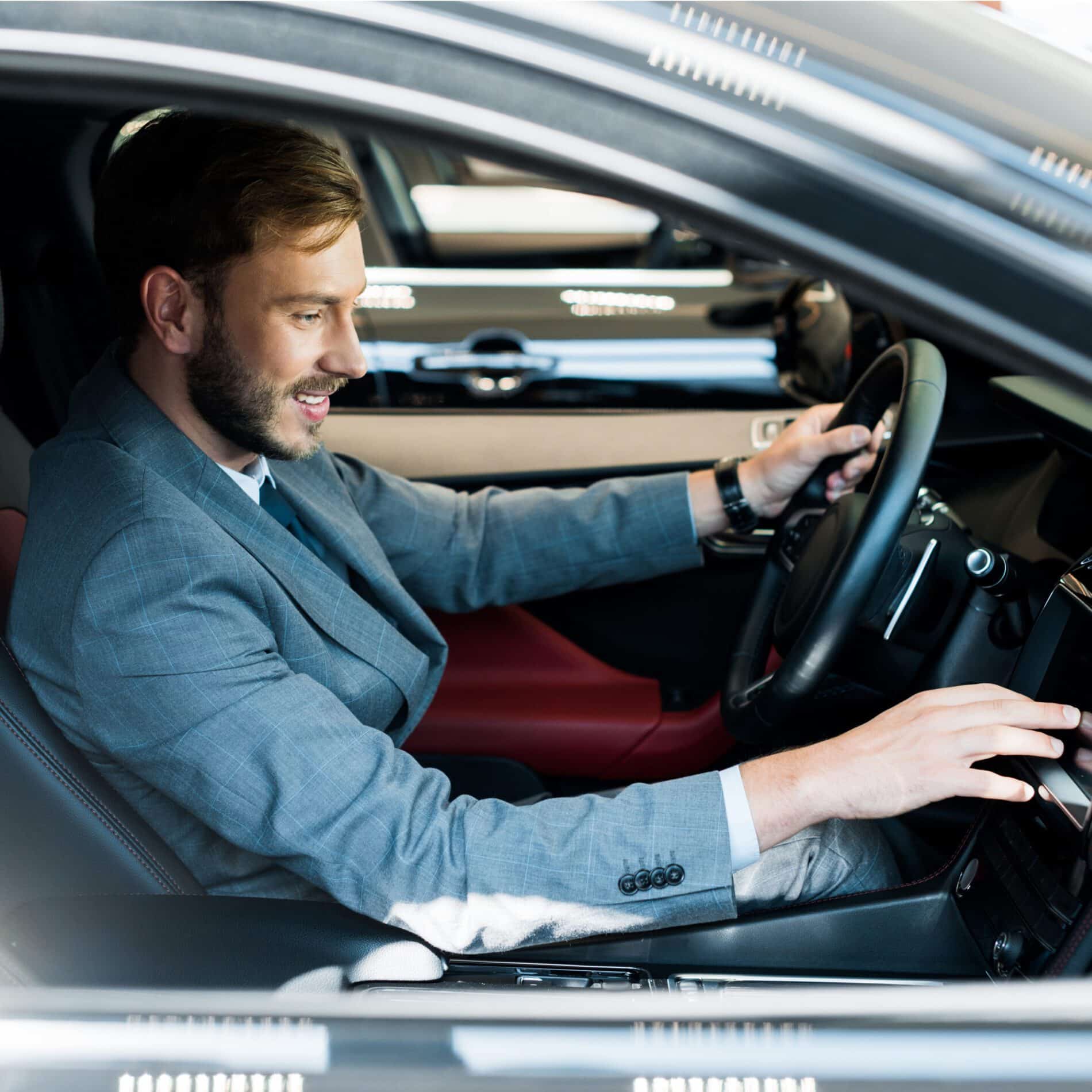 selective focus of cheerful bearded driver sitting 2024 11 13 19 26 12 utc scaled