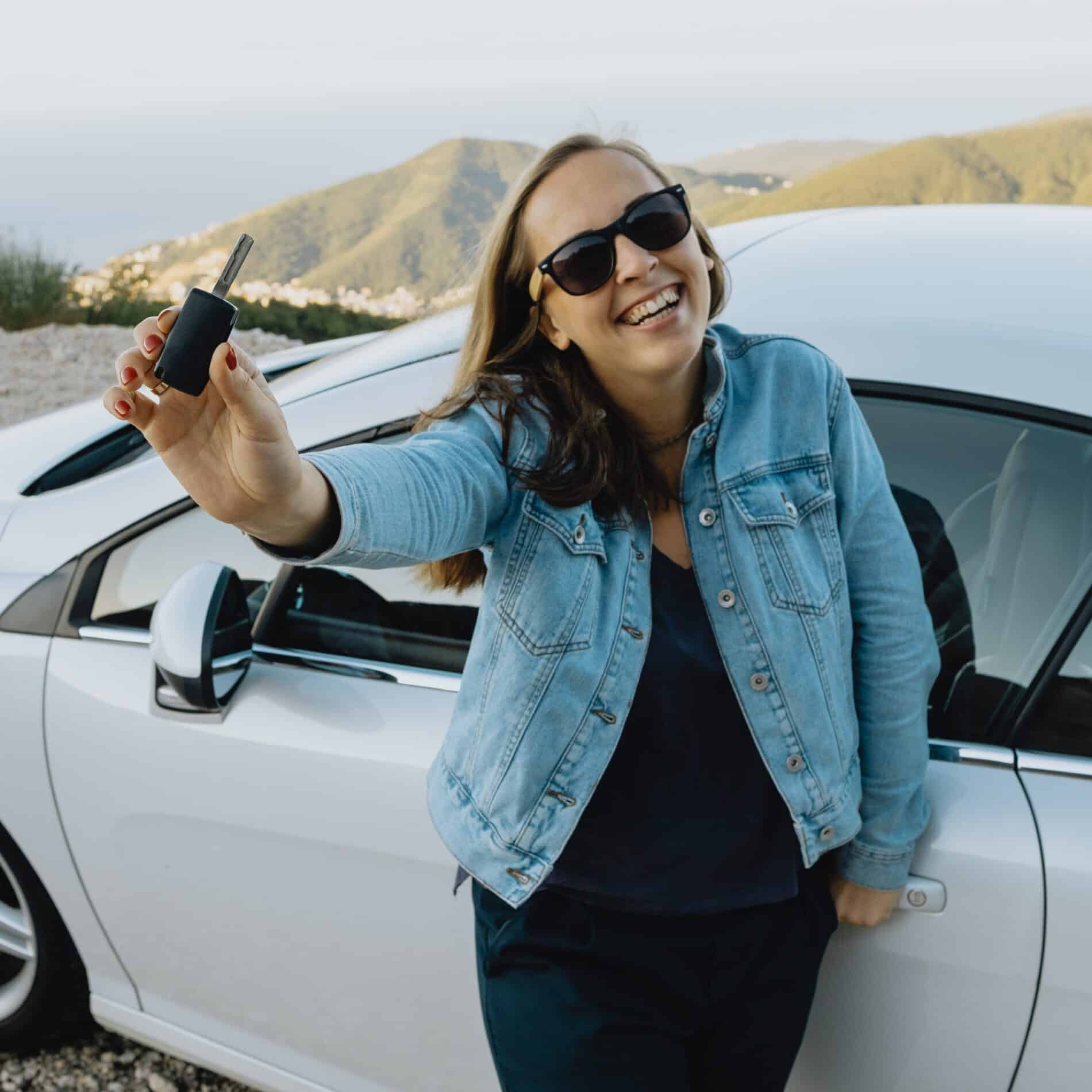 smiling woman showing new rental car keys 2024 09 23 10 53 46 utc scaled